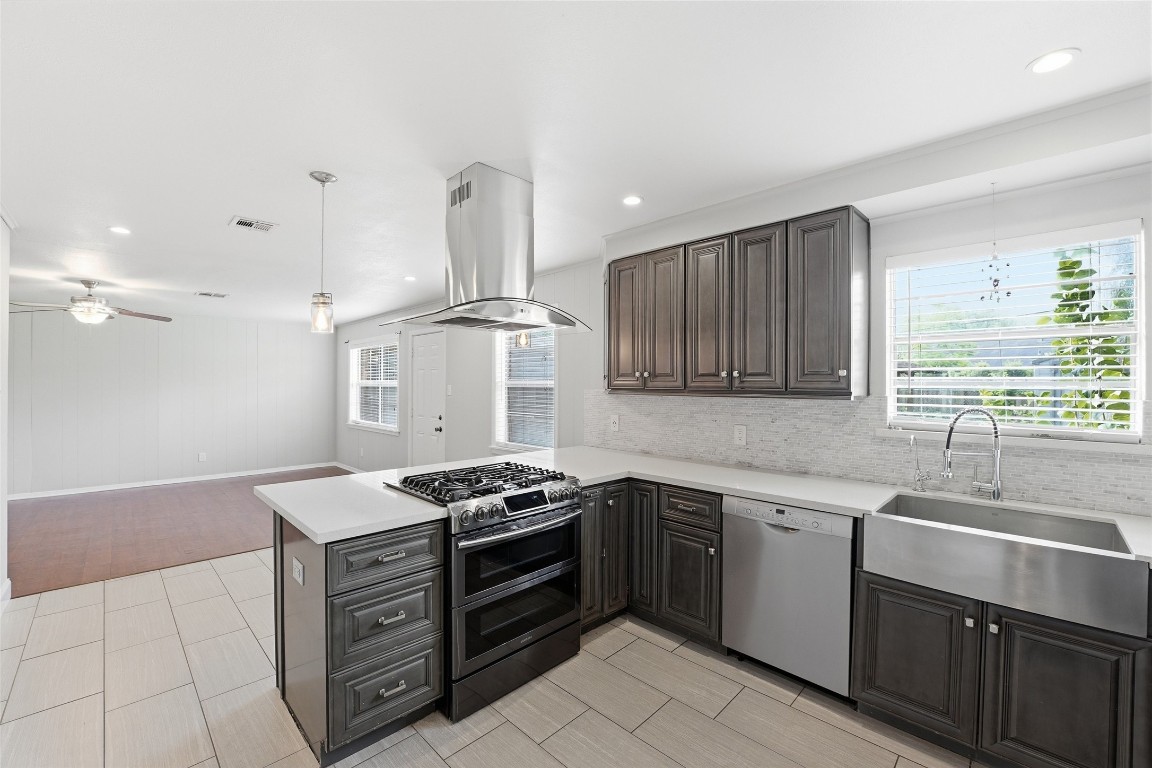 5907 Peg Street Houston, TX 77092 - Photo 4 of 21 a kitchen with stainless steel appliances a sink stove and cabinets