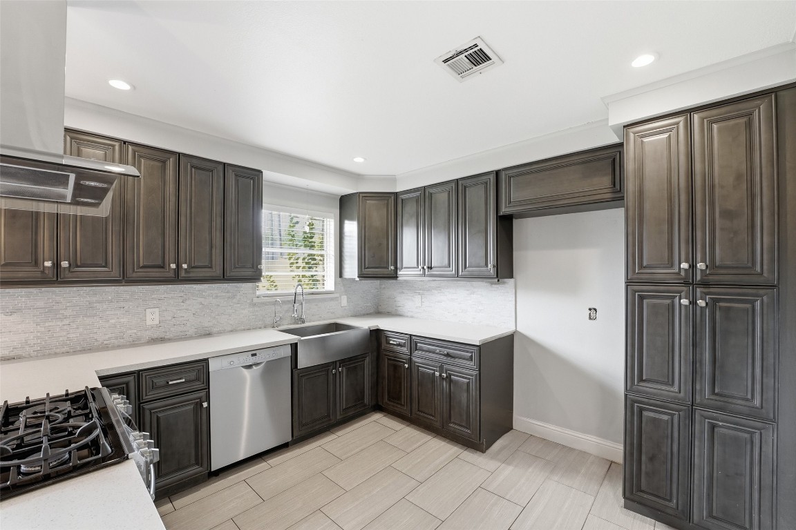 5907 Peg Street Houston, TX 77092 - Photo 5 of 21 a kitchen with stainless steel appliances granite countertop a sink stove and refrigerator