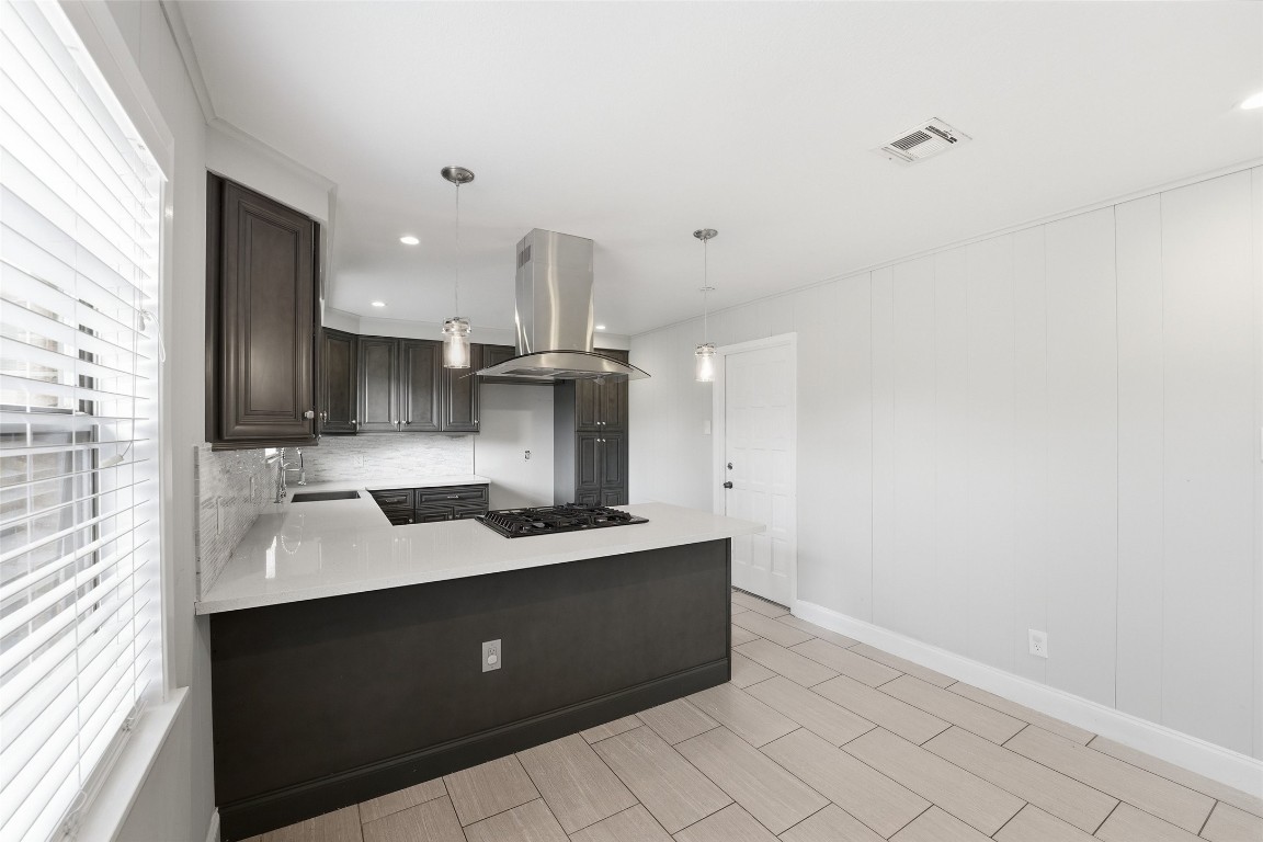 5907 Peg Street Houston, TX 77092 - Photo 6 of 21 a kitchen with a sink cabinets and window