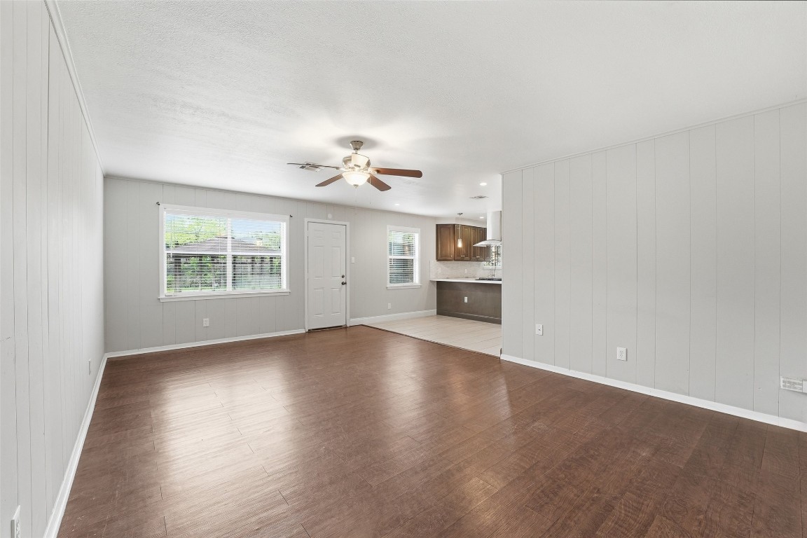 5907 Peg Street Houston, TX 77092 - Photo 8 of 21 an empty room with wooden floor chandelier and windows