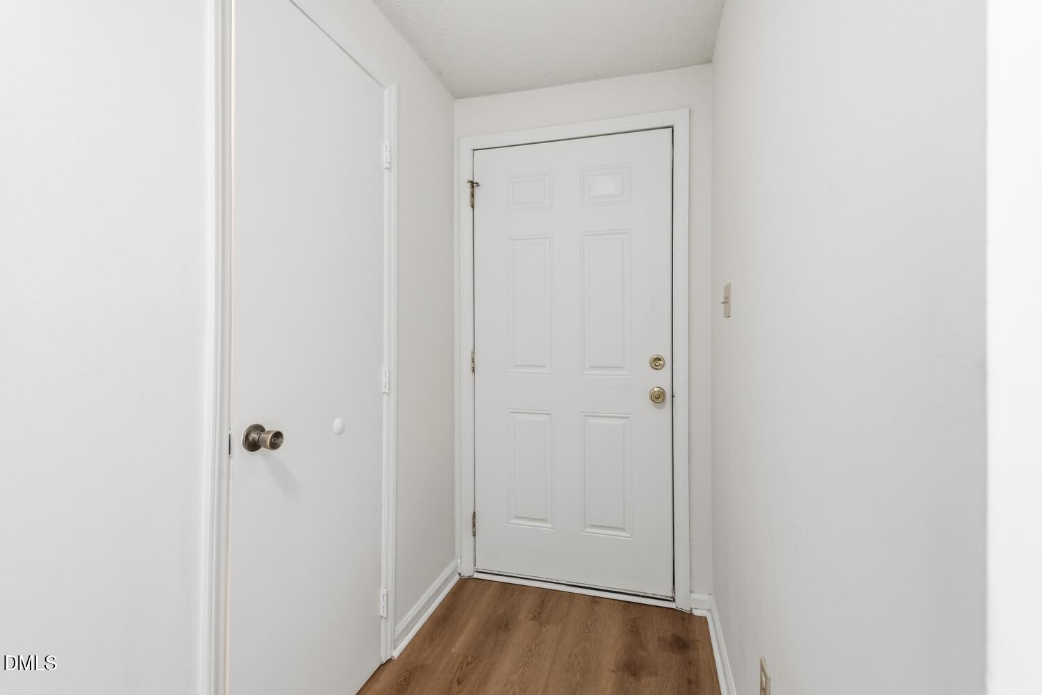 1135 Villa Green Court Raleigh, NC 27612 - Photo 4 of 17 a view of a hallway with wooden floor