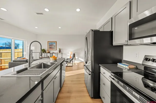 a kitchen with a refrigerator stove and a sink