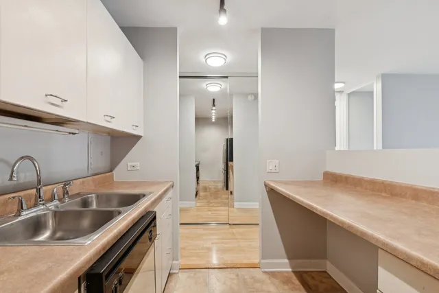 a kitchen with kitchen island a sink and a refrigerator