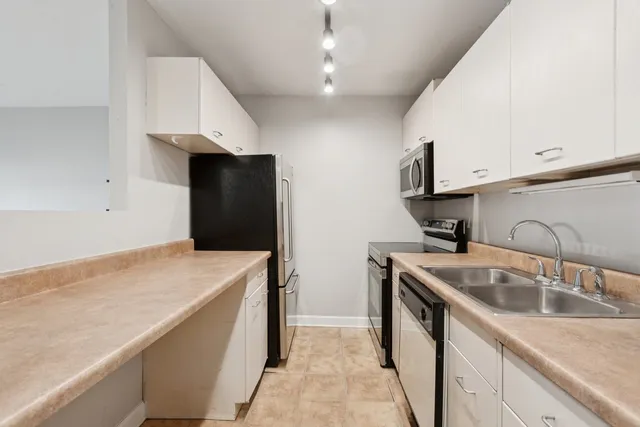 a kitchen with a sink and a refrigerator