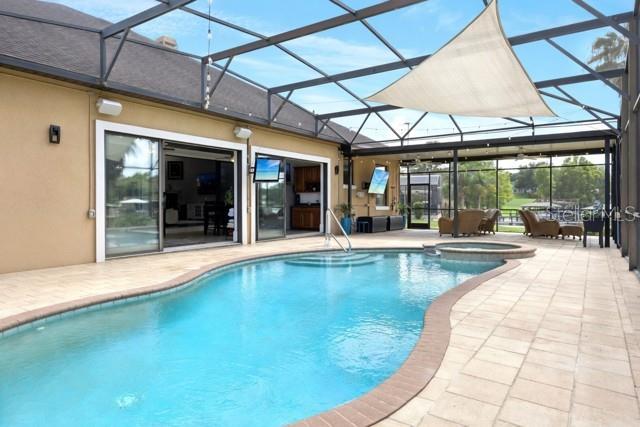11325 Preston Cove Road Clermont, FL 34711 - Photo 27 of 58 a view of a patio with a table and chairs under an umbrella