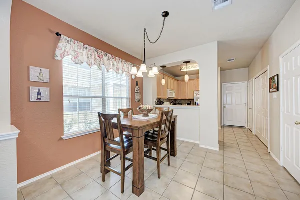 a view of a dining room with furniture and window