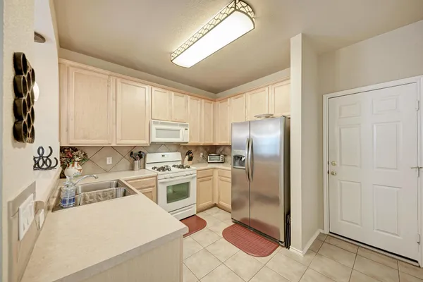 a kitchen with a refrigerator sink and stove