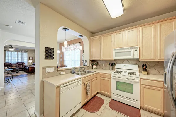 a view of a kitchen with a stove a sink and a window