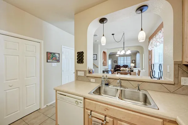 a kitchen with a sink and a clock on the wall