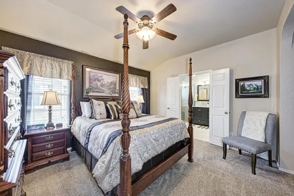 a bedroom with a bed and a chandelier
