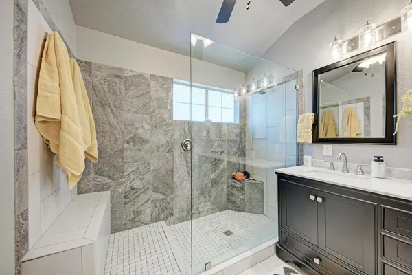 a bathroom with a sink mirror and a bathtub