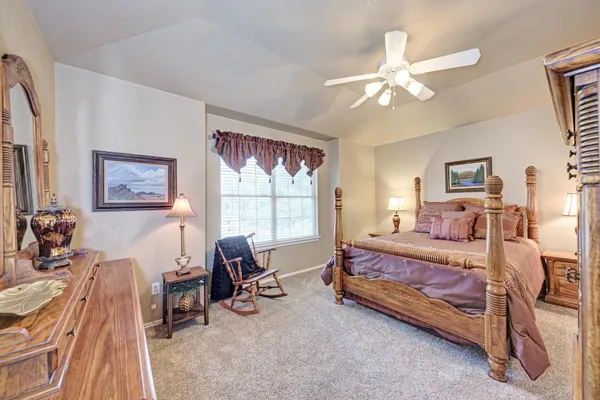 a bed room with a bed and a chair