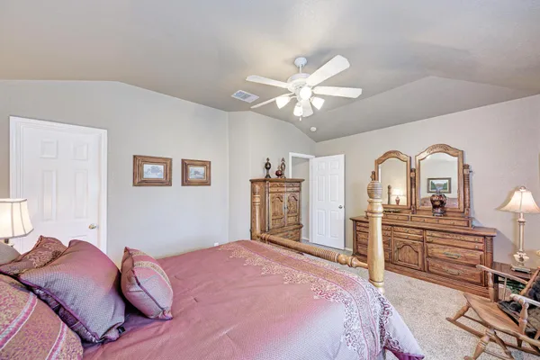 a bedroom with a bed dresser and a window