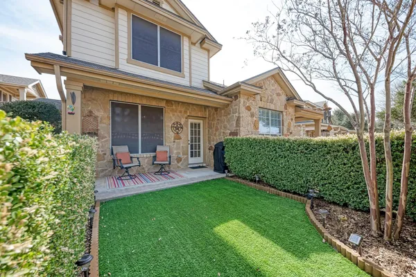 a view of a house with a yard and sitting area
