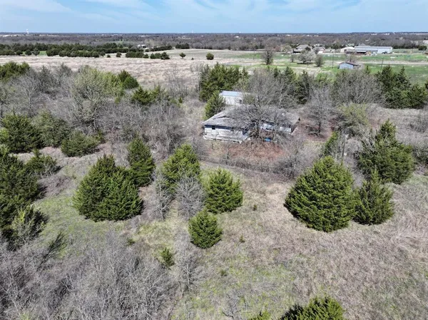 an aerial view of a forest with houses