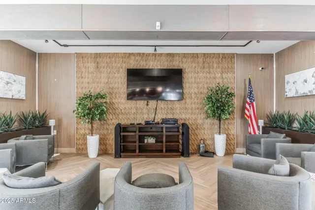 a living room with furniture a potted plant and a fireplace
