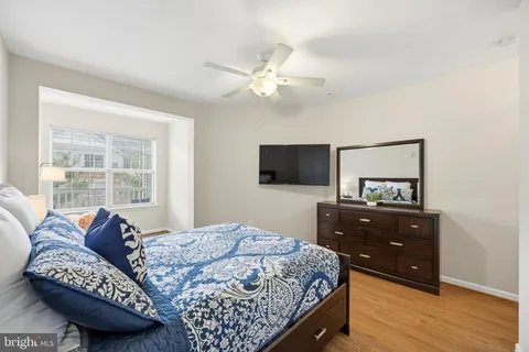 a bedroom with a bed and a tv on dresser