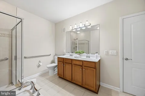 a bathroom with a sink and mirror with toilet