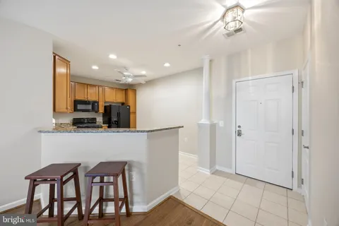 a view of kitchen with refrigerator and cabinets