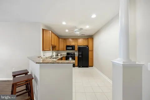 a view of kitchen with refrigerator stove and microwave