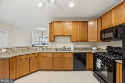 a kitchen with a sink stove top oven and cabinets