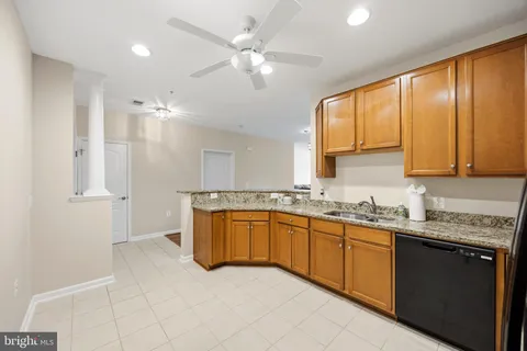 a kitchen with stainless steel appliances granite countertop a sink and cabinets