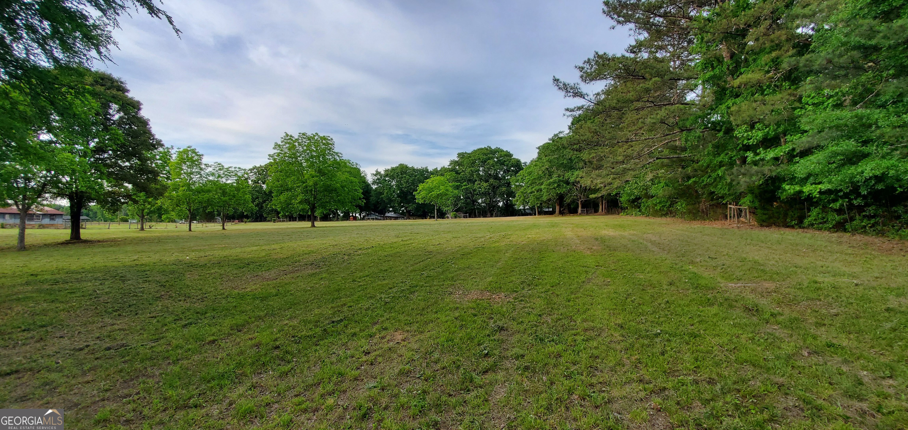 1135 Burger Road Watkinsville, GA 30677 - Photo 13 of 20 a view of a green field with trees in the background