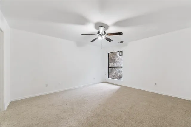 an empty room with a empty space and a ceiling fan