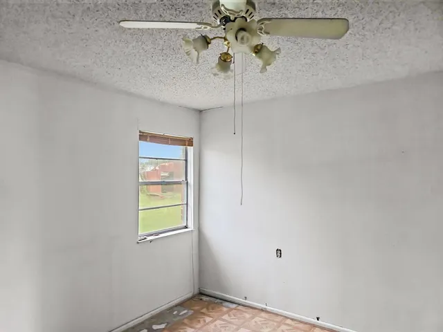 a bathroom with a granite countertop toilet sink and mirror