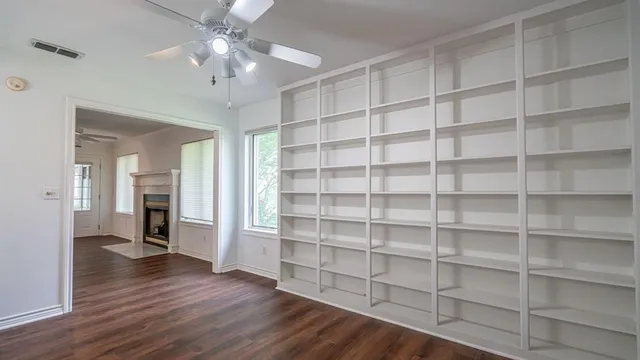 a view of a workspace with furniture and wooden floor