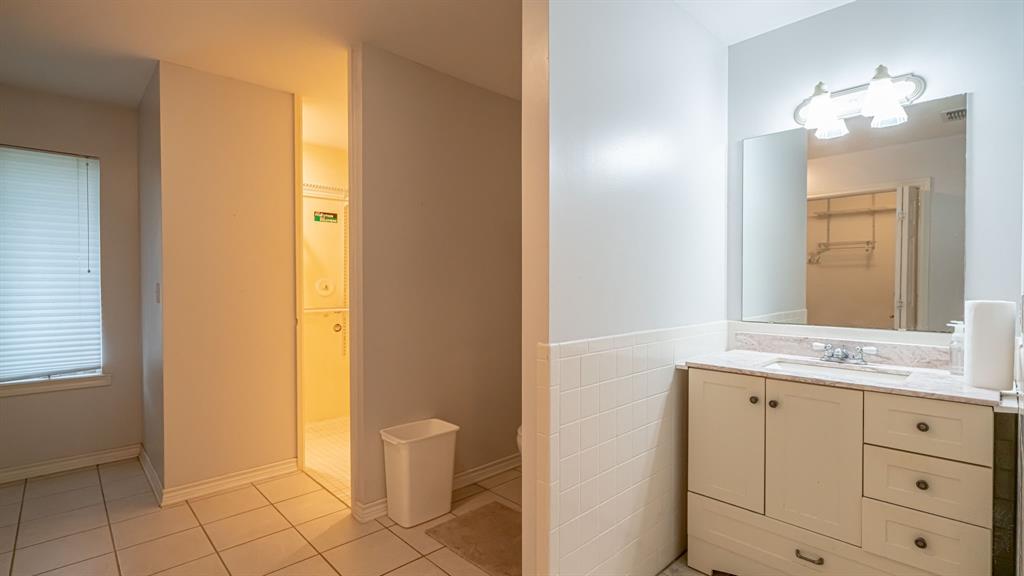 111 Scenic Drive Dublin, TX 76446 - Photo 18 of 40 a bathroom with a granite countertop sink and a mirror