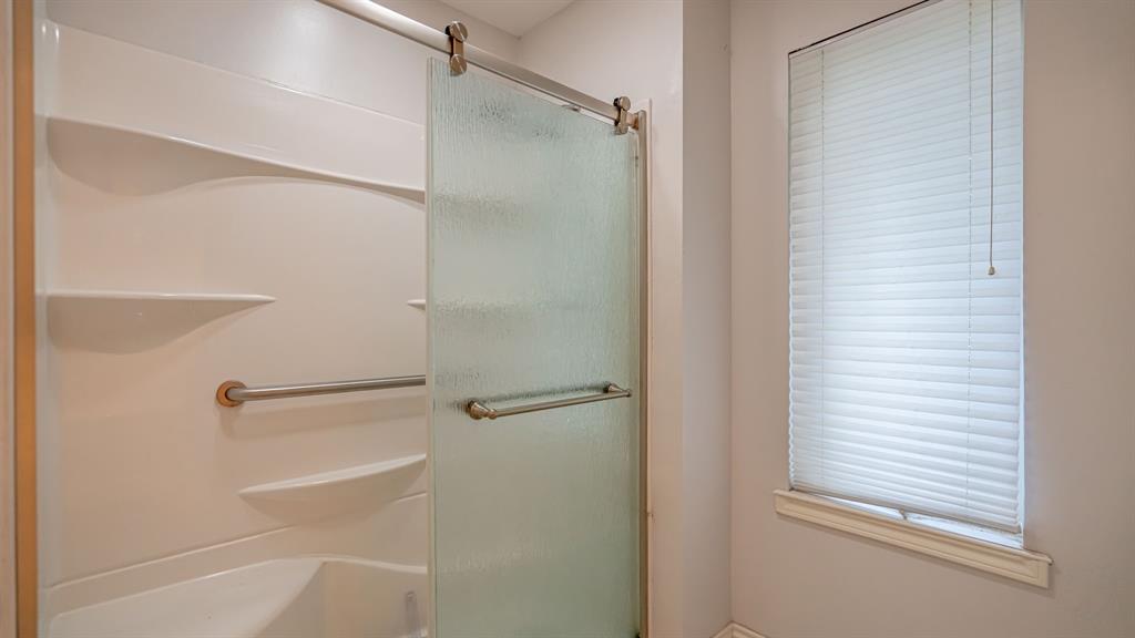 111 Scenic Drive Dublin, TX 76446 - Photo 20 of 40 a bathroom with a glass door shower