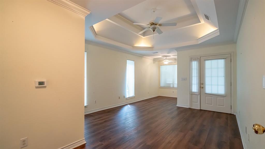 111 Scenic Drive Dublin, TX 76446 - Photo 21 of 40 an empty room with wooden floor and windows