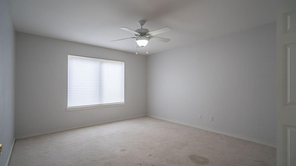 111 Scenic Drive Dublin, TX 76446 - Photo 27 of 40 an empty room with a window and a fan
