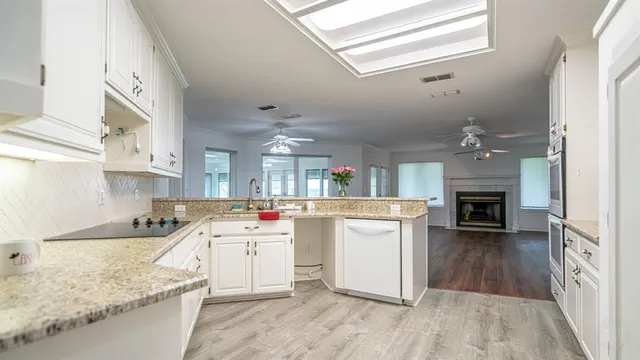 a kitchen with cabinets and wooden floor