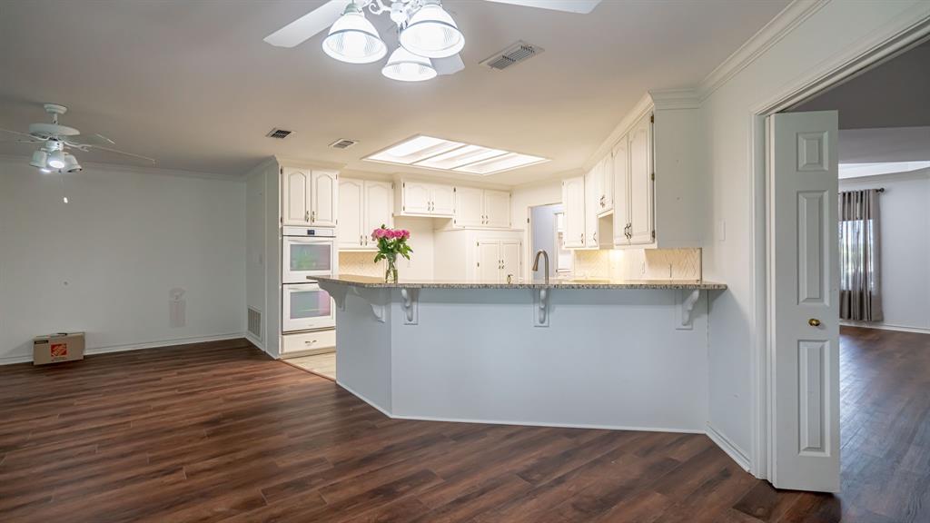 111 Scenic Drive Dublin, TX 76446 - Photo 9 of 40 an empty room with wooden floor and windows