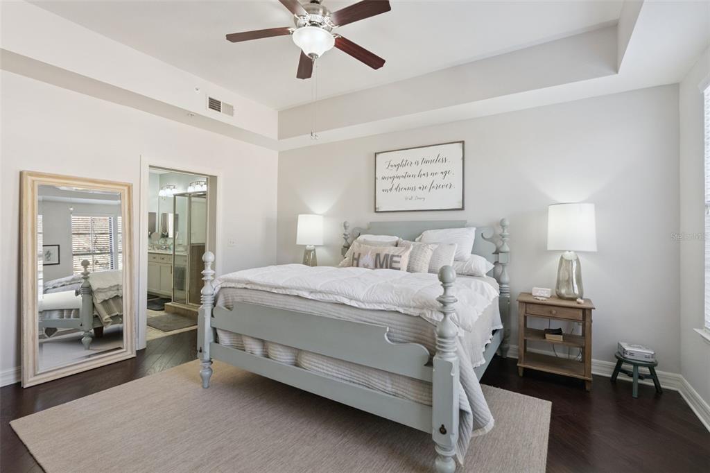 515 Mirasol Circle, Unit 302 Celebration, FL 34747 - Photo 23 of 60 a bedroom with a bed and a chandelier