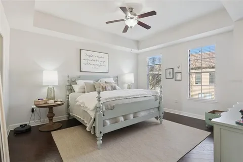 a bedroom with a bed a window and dresser