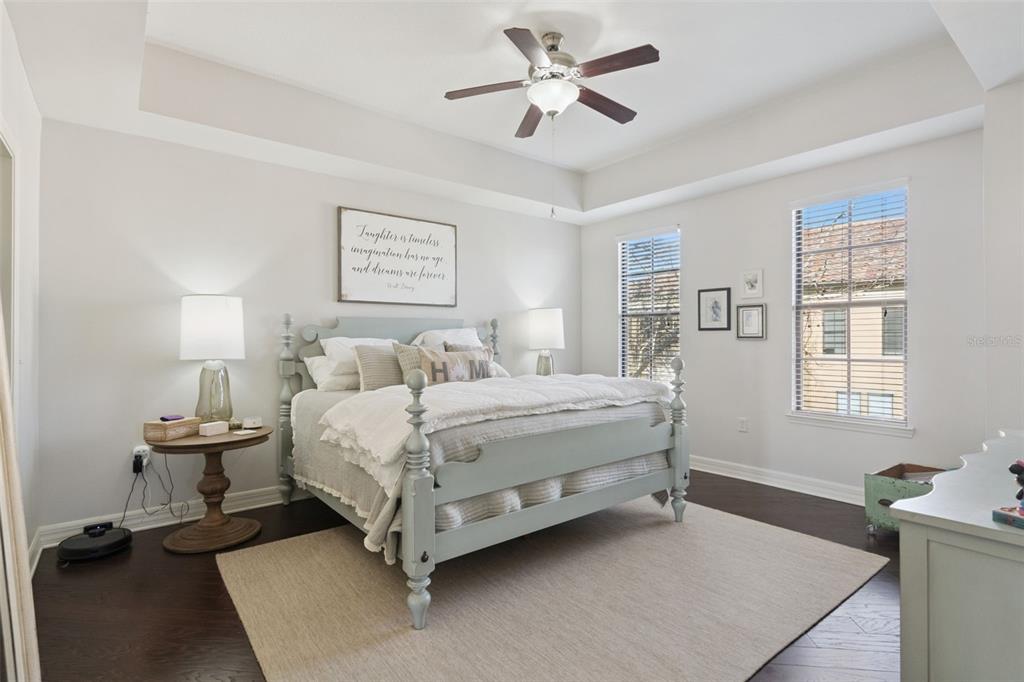 515 Mirasol Circle, Unit 302 Celebration, FL 34747 - Photo 24 of 60 a spacious bedroom with a bed and a window