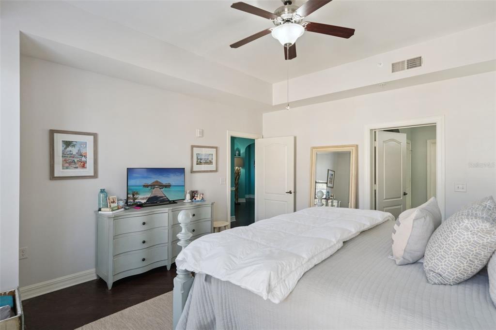 515 Mirasol Circle, Unit 302 Celebration, FL 34747 - Photo 26 of 60 a bedroom with a large bed and a chandelier