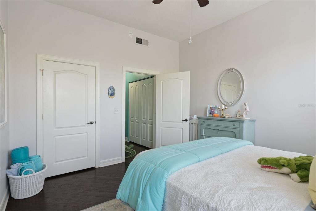 515 Mirasol Circle, Unit 302 Celebration, FL 34747 - Photo 30 of 60 a bedroom with a bed and a potted plant