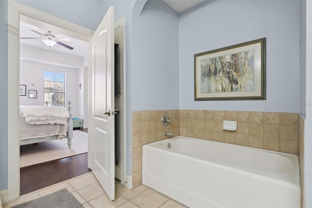 515 Mirasol Circle, Unit 302 Celebration, FL 34747 - Photo 31 of 60 a bathroom with a bathtub and a shower