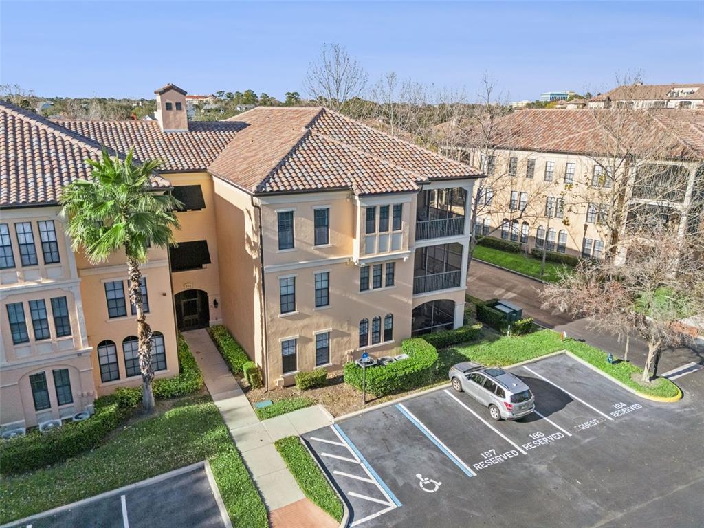 515 Mirasol Circle, Unit 302 Celebration, FL 34747 - Photo 53 of 60 a view of a white house next to a yard with big trees