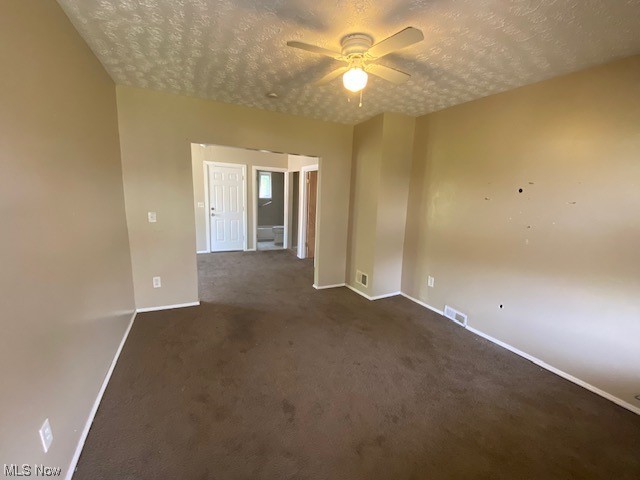 921 Rudyard Road Cleveland, OH 44110 - Photo 3 of 31 Carpeted spare room with ceiling fan and a textured ceiling