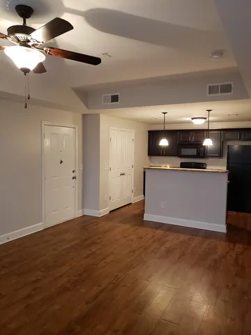 a kitchen with stainless steel appliances granite countertop a refrigerator and a stove top oven