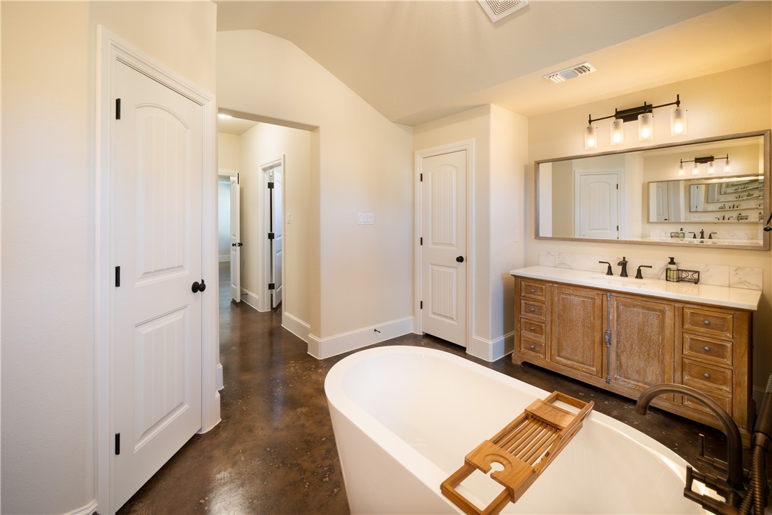315 Bluestem Cove Georgetown, TX 78633 - Photo 14 of 35 a spacious bathroom with a mirror a sink and shower