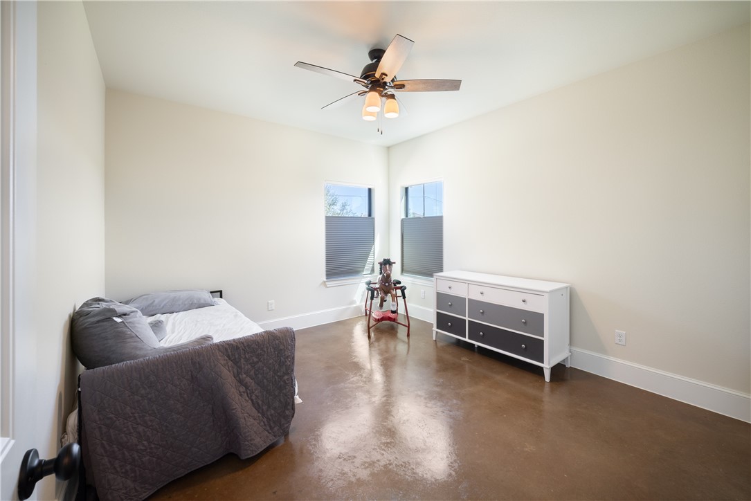 315 Bluestem Cove Georgetown, TX 78633 - Photo 23 of 35 a bedroom with furniture and a ceiling fan