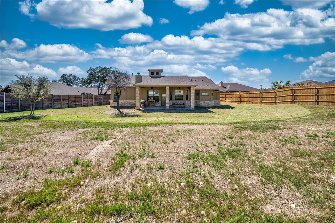 315 Bluestem Cove Georgetown, TX 78633 - Photo 28 of 35 a view of a big yard with a house in the background