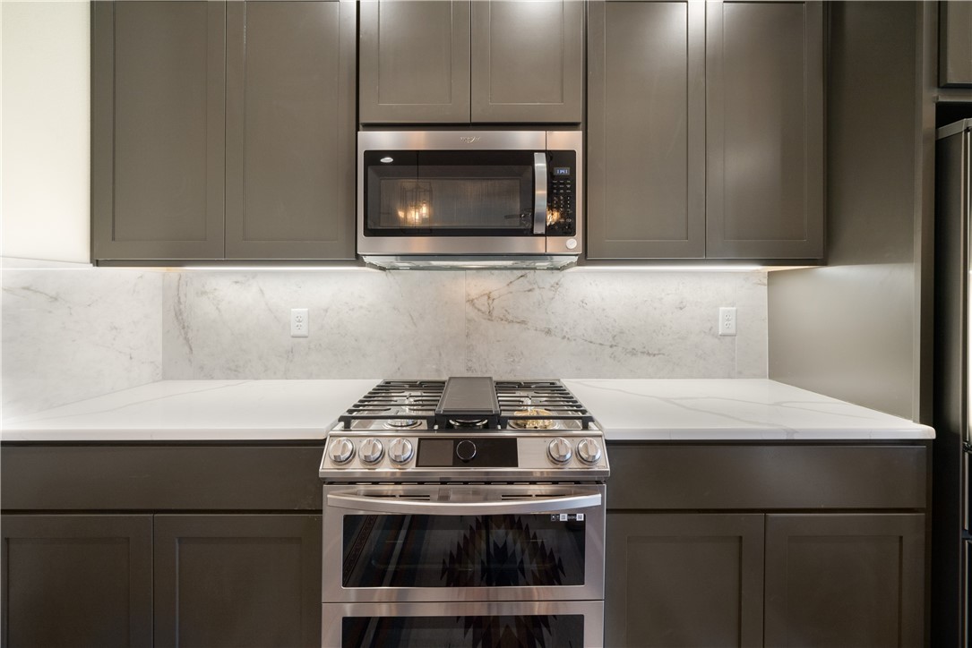 315 Bluestem Cove Georgetown, TX 78633 - Photo 8 of 35 a kitchen with a stove and a microwave