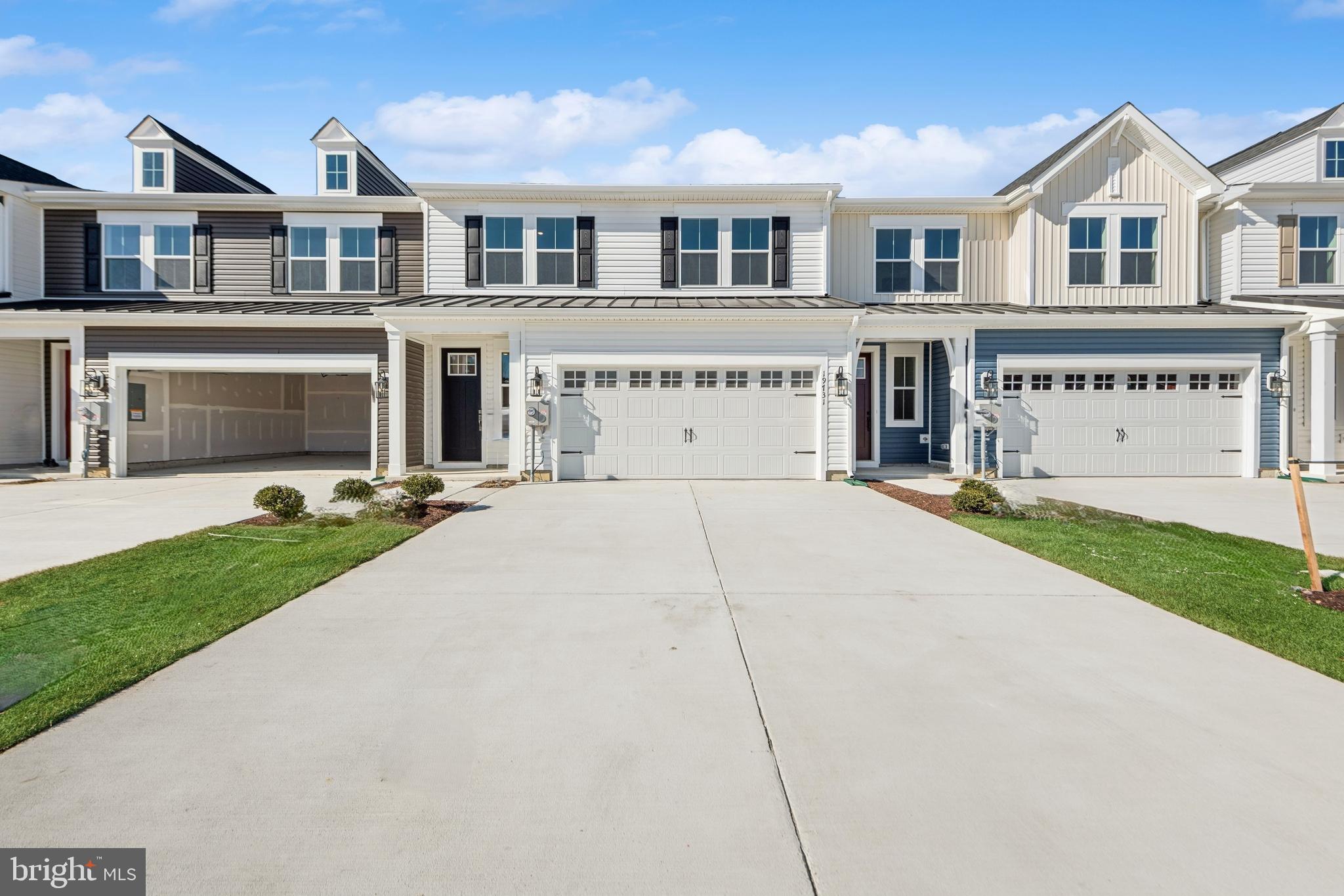 a view of house with yard and car parked